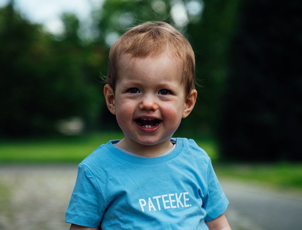 Baby met blauwe T-shirt metopdruk PATEEKE.