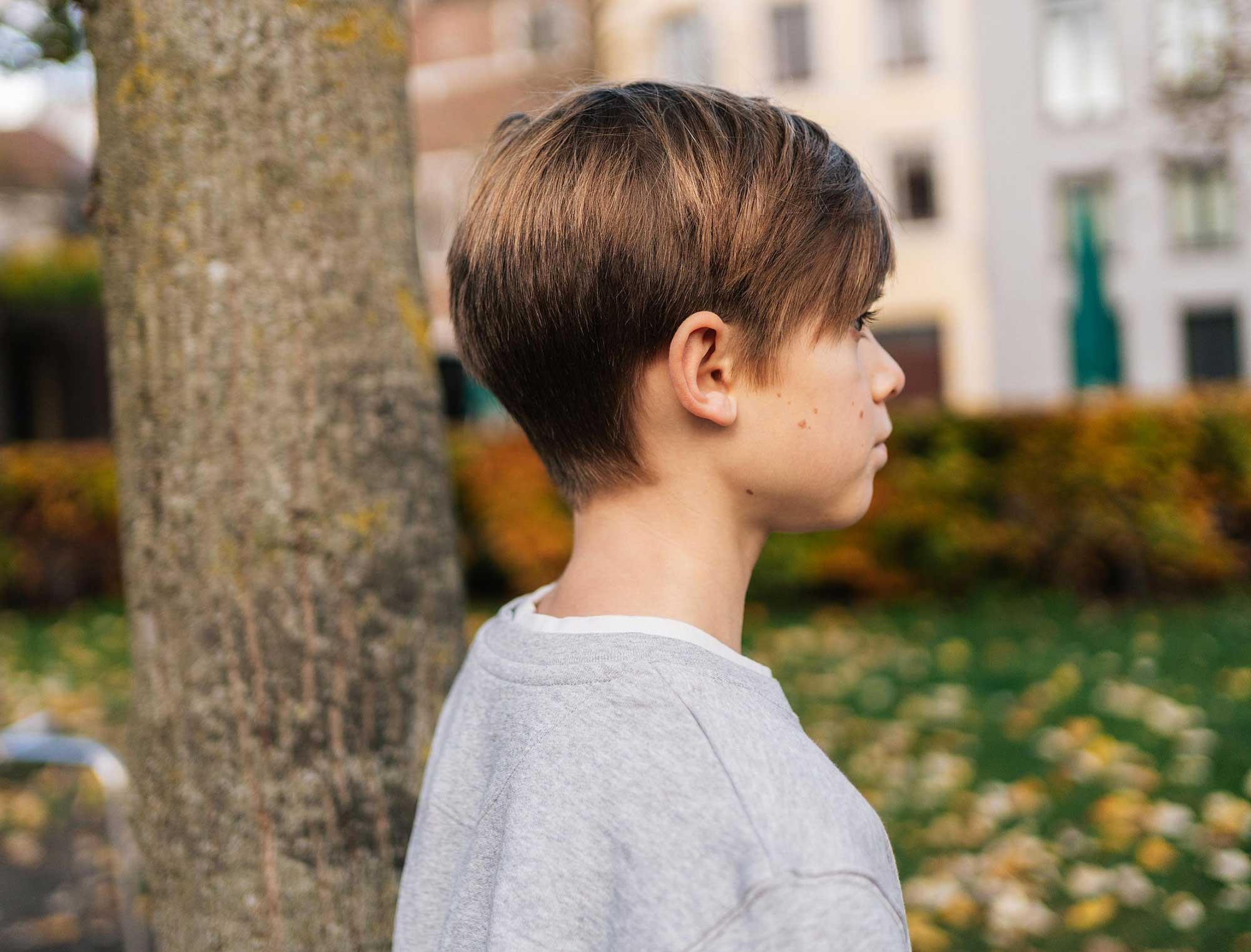 Close-up van een grijze sweater met opdruk SJAREL. voor kinderen