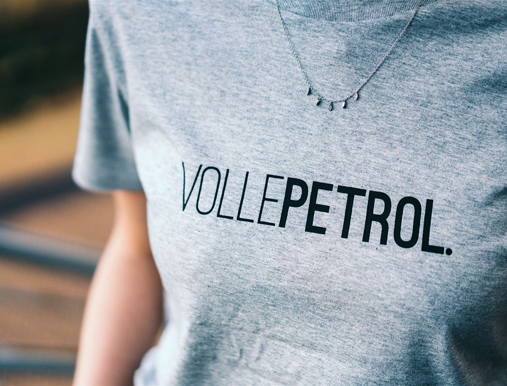 Close-up van een grijze T-shirt met opdruk VOLLEPETROL.