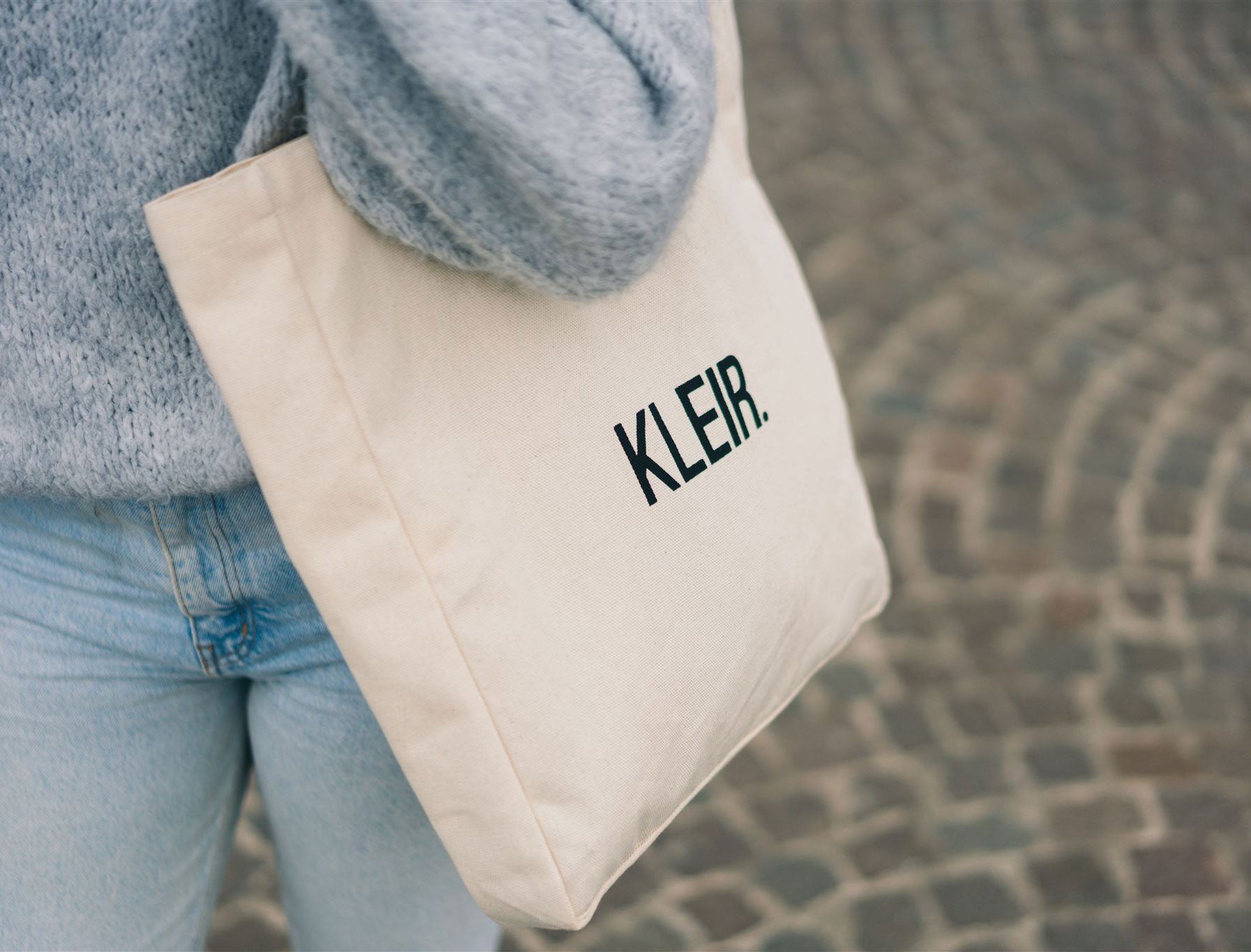 Close-up van een totebag met opdruk KLEIR.